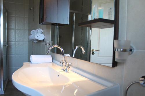 a bathroom with a sink and a mirror at Connemara Lake Hotel in Oughterard