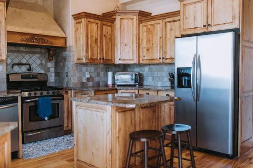 a kitchen with wooden cabinets and a stainless steel refrigerator at Mountain Getaway! in Eden