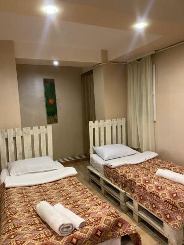 Mini Hostel N.Tigranyan 5 في يريفان: غرفة بسريرين عليها مناشف