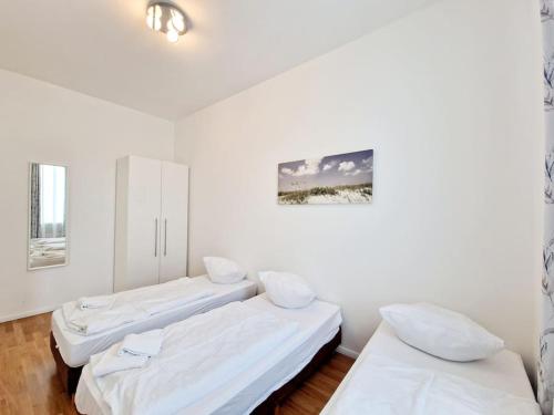 two beds in a room with white walls at Luxury apartament in the heart of Berlin 45 in Berlin