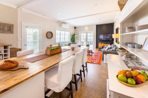 a kitchen and living room with a large wooden counter top at The Edward Townhouse 155 - Steps to Town in Orange