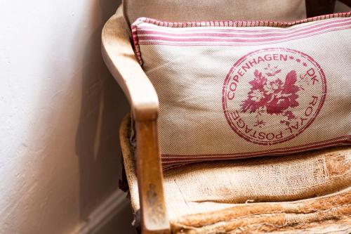 a pillow sitting on top of a chair at The Edward Townhouse 155 - Steps to Town in Orange