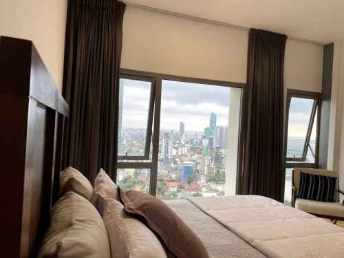 a bedroom with a bed with a view of a city at Altair Colombo - View, Location, Ultra Luxury! in Colombo