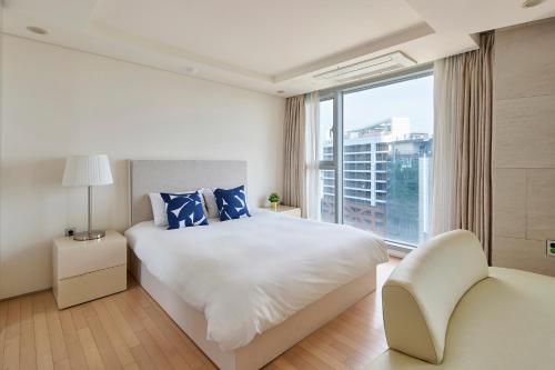 Ένα ή περισσότερα κρεβάτια σε δωμάτιο στο The Island Blue Hotel