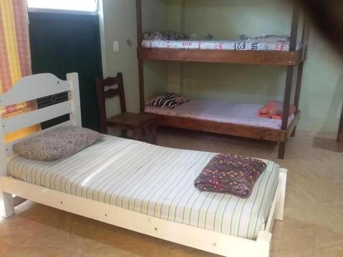 a bedroom with two bunk beds in a room at EL CALEUCHE in Rio das Ostras