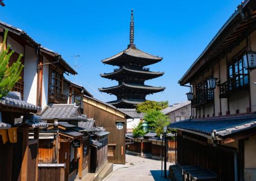 a pagoda in the middle of a city with buildings at Kyoto Yamashina Hotel Sanraku in Kyoto