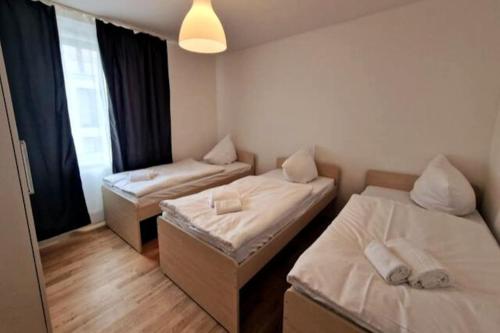 a small room with two beds and a window at Cozy apartment in the center of Berlin 33 in Berlin