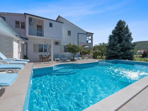 a swimming pool in front of a house at Beautiful Holiday Home in Neoric in Neorić