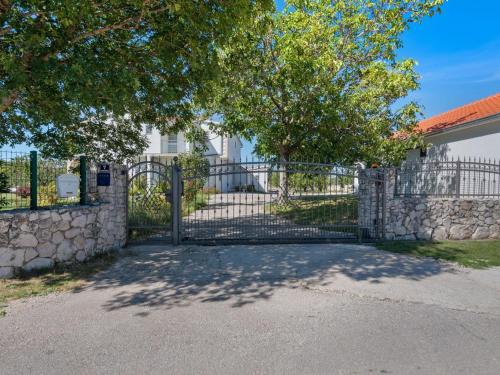 a gate to a house with a stone wall at Beautiful Holiday Home in Neoric in Neorić