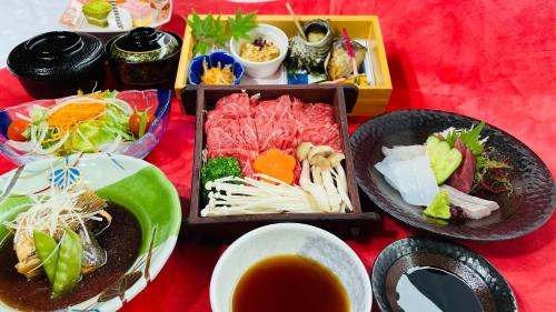 a table with plates of food and a bowl of soup at Route Inn Grantia Aoshima Taiyokaku in Miyazaki