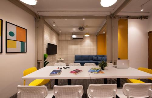 a meeting room with a white table and chairs at THE BAUHAUS in Mumbai