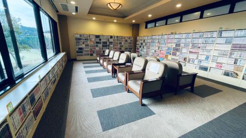 a library with a row of chairs and books at Route Inn Grantia Aoshima Taiyokaku in Miyazaki
