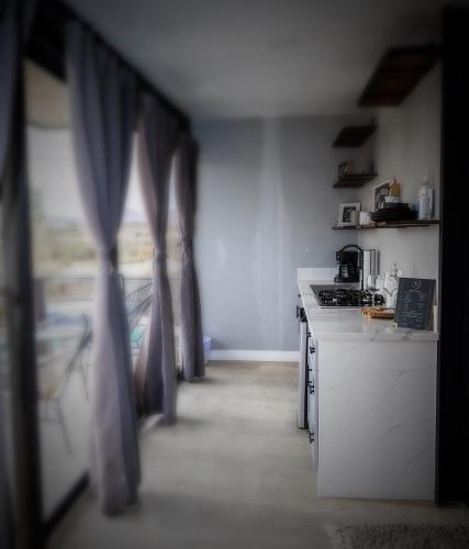 a kitchen with a counter and a stove top oven at Finca Cazosa in Valle de Guadalupe