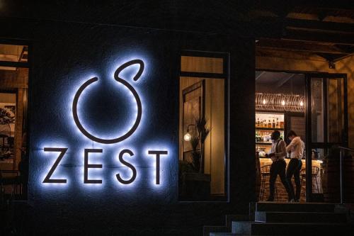 a neon sign on the side of a restaurant at Lowveld Living Guesthouse in Nelspruit