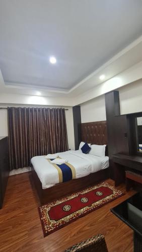 a bedroom with a bed and a table in it at Dream Palace Resort in Kathmandu