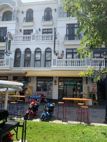 a building with motorcycles parked in front of it at Golden Lotus Homestay Phú Quốc in Phu Quoc