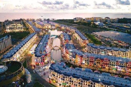 an aerial view of a city with a river and buildings at Golden Lotus Homestay Phú Quốc in Phu Quoc