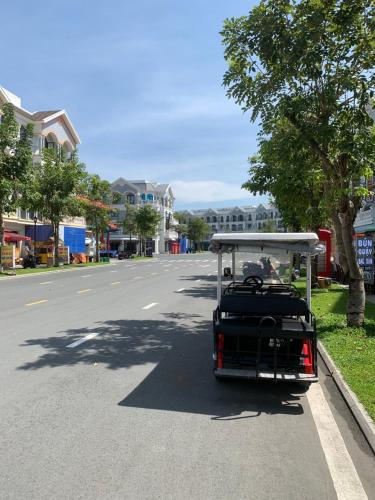 a golf cart is driving down a street at Golden Lotus Homestay Phú Quốc in Phu Quoc