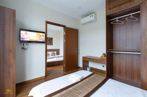 a bedroom with a bed and a sink and a mirror at Golden Lotus Homestay Phú Quốc in Phu Quoc