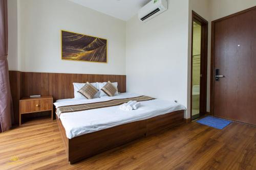a bedroom with a bed and a sliding glass door at Golden Lotus Homestay Phú Quốc in Phu Quoc