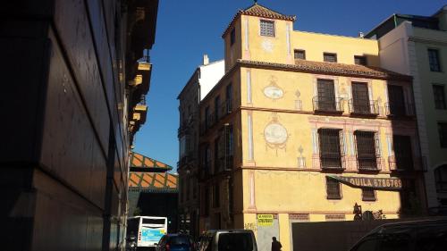 a clock tower on the side of a building at The Lights Hostel in Málaga