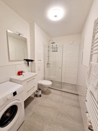 a white bathroom with a toilet and a shower at Nice apartment in the heart of Berlin 13 in Berlin