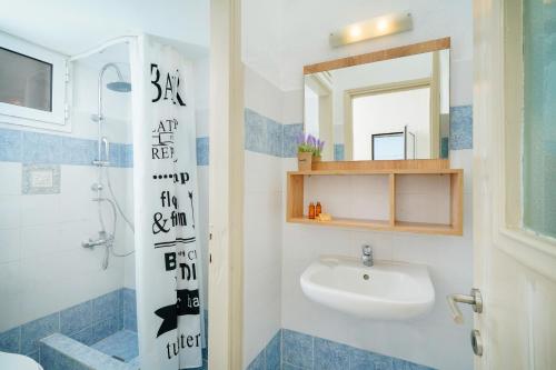 La salle de bains est pourvue d'un lavabo, de toilettes et d'un miroir. dans l'établissement Evelyn Studios, à Olympiada