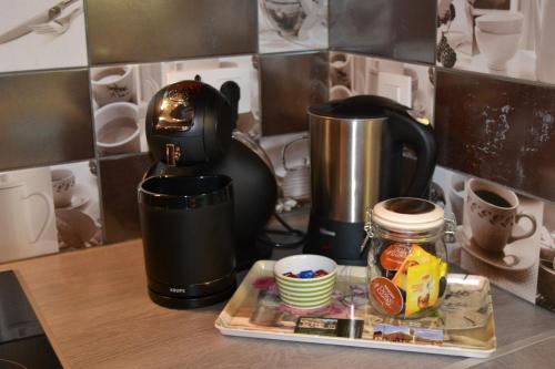 a kitchen counter with a coffee pot and a tray of food at Gite Spa les Estinnes in Estinnes-au-Mont