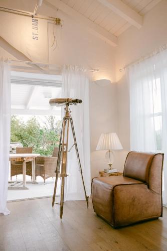 a tripod in a living room with a couch and a lamp at PAVI APARTMENTS Life Style House with private pool in Kornić