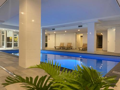 a swimming pool in the middle of a house at Fletcher Hotel Jan van Scorel in Schoorl