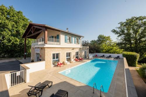 a home with a swimming pool and a house at Garden & City Lyon - Lissieu in Lissieu