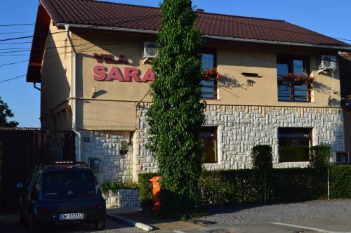 a car parked in front of a house at Vila Sara in Chişoda