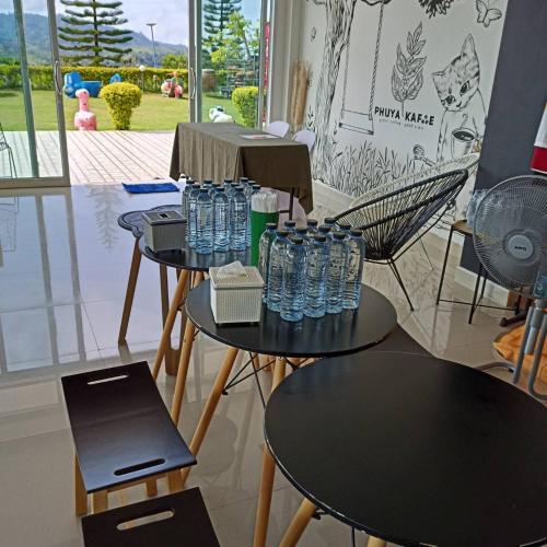 a group of tables with water bottles on them at Phuyafahsai The Resort Khao Kho in Khao Kho