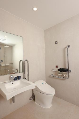 a bathroom with a toilet and a sink and a mirror at Lahan Hotel Jeonju in Jeonju