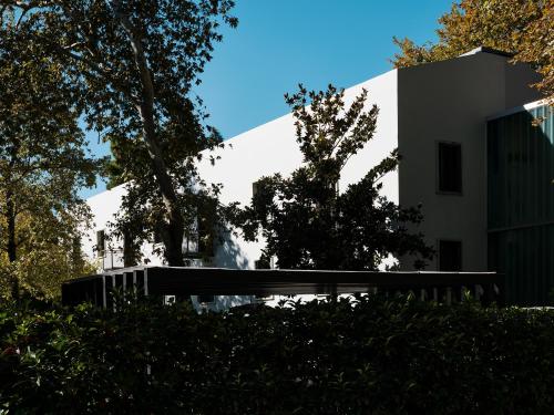 a bench in front of a white building at The Twentyone in Athens