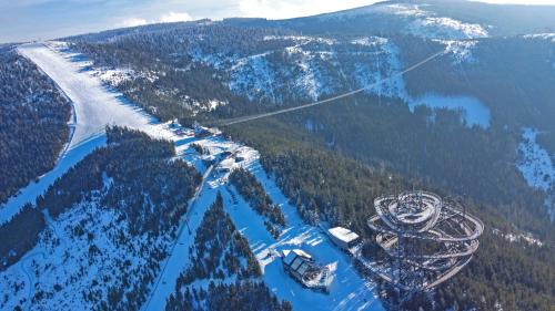 a gondola flying over a snow covered mountain at Wellness Hotel Vista in Dolní Morava