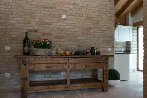 a kitchen with a wooden table with a bottle of wine at Ca' Gemma in Treviso