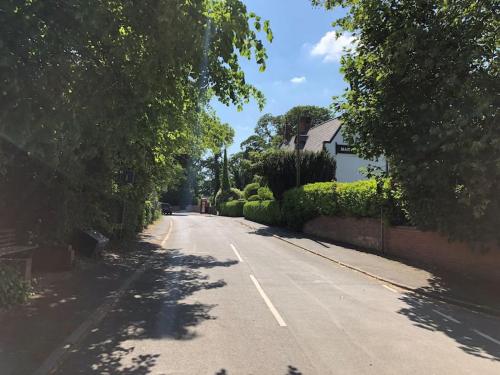 an empty street with trees on the side of the road at The Barn in Nottingham