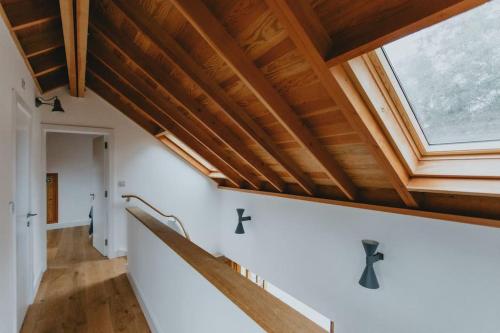 an attic room with a skylight and wooden ceilings at The Barn in Nottingham