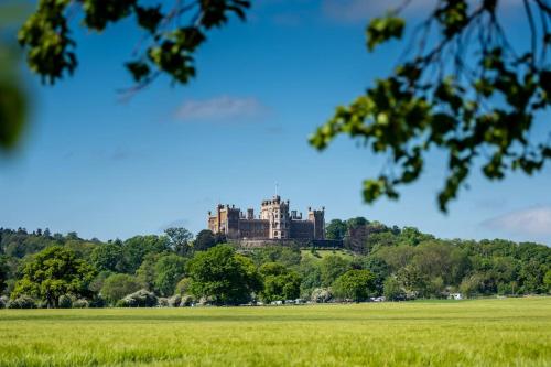 a castle on a hill in a field at The Barn in Nottingham