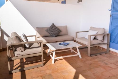 a living room with two chairs and a coffee table at Cas Saliners - Ses Illetes in La Savina