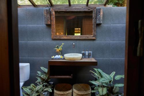 a bathroom with a sink and a mirror at Kayu Mama Resort and Spa in Uluwatu