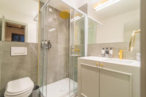a bathroom with a shower and a toilet and a sink at The Melegran in Rovinj