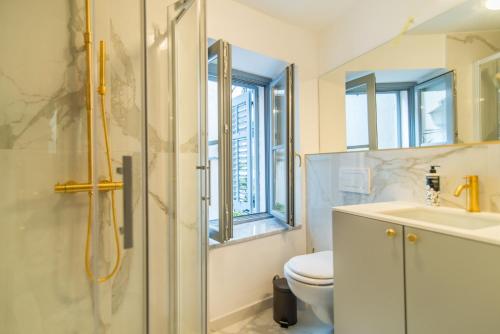 a bathroom with a shower and a toilet and a sink at The Melegran in Rovinj