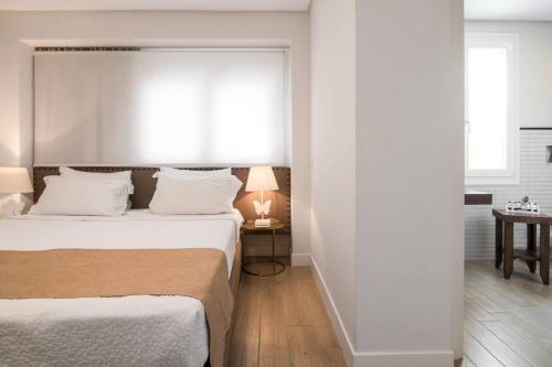 a bedroom with a large bed and a window at Kappa Resort in Paliouri