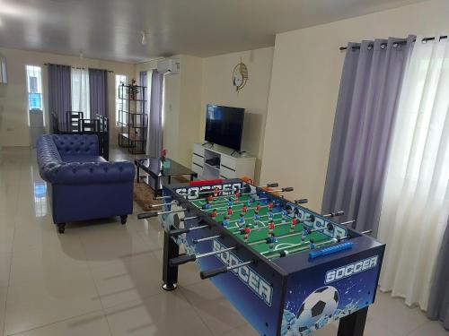 a living room with a table with a soccer game on it at 3 bed 3 bath Friendly, Friendship area, Fibre bdb in Angeles