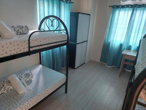 a small room with two bunk beds and a table at 3 bed 3 bath Friendly, Friendship area, Fibre bdb in Angeles