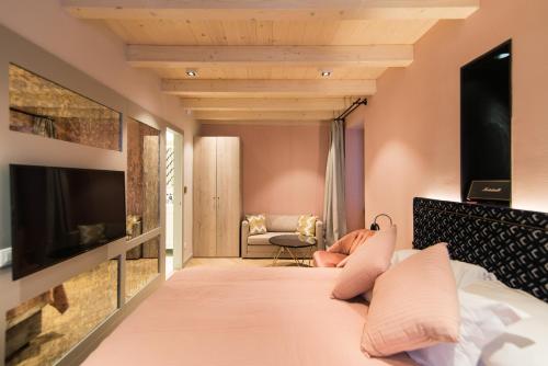 a hotel room with a bed and a tv at The Melegran in Rovinj