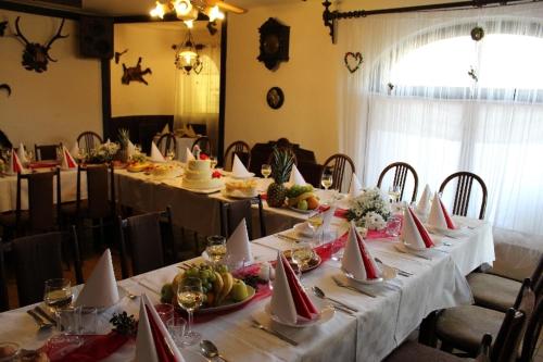 a dining room with long tables with white tablecloths at Penzion St. Florian Příbor in Příbor