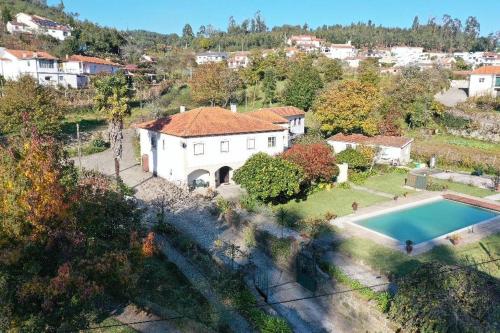 an aerial view of a house with a swimming pool at THE RIVER HOUSE - Termas Guesthouse in Termas de Sao Pedro do Sul